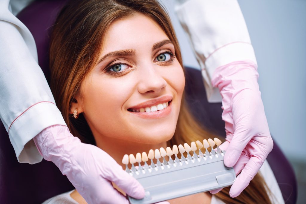 Beautiful woman smile with healthy teeth whitening. Matching shades of the implants. Healthy Smile.